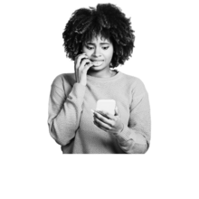 A young Black woman with braces and natural hair looking nervous about what is on her phone